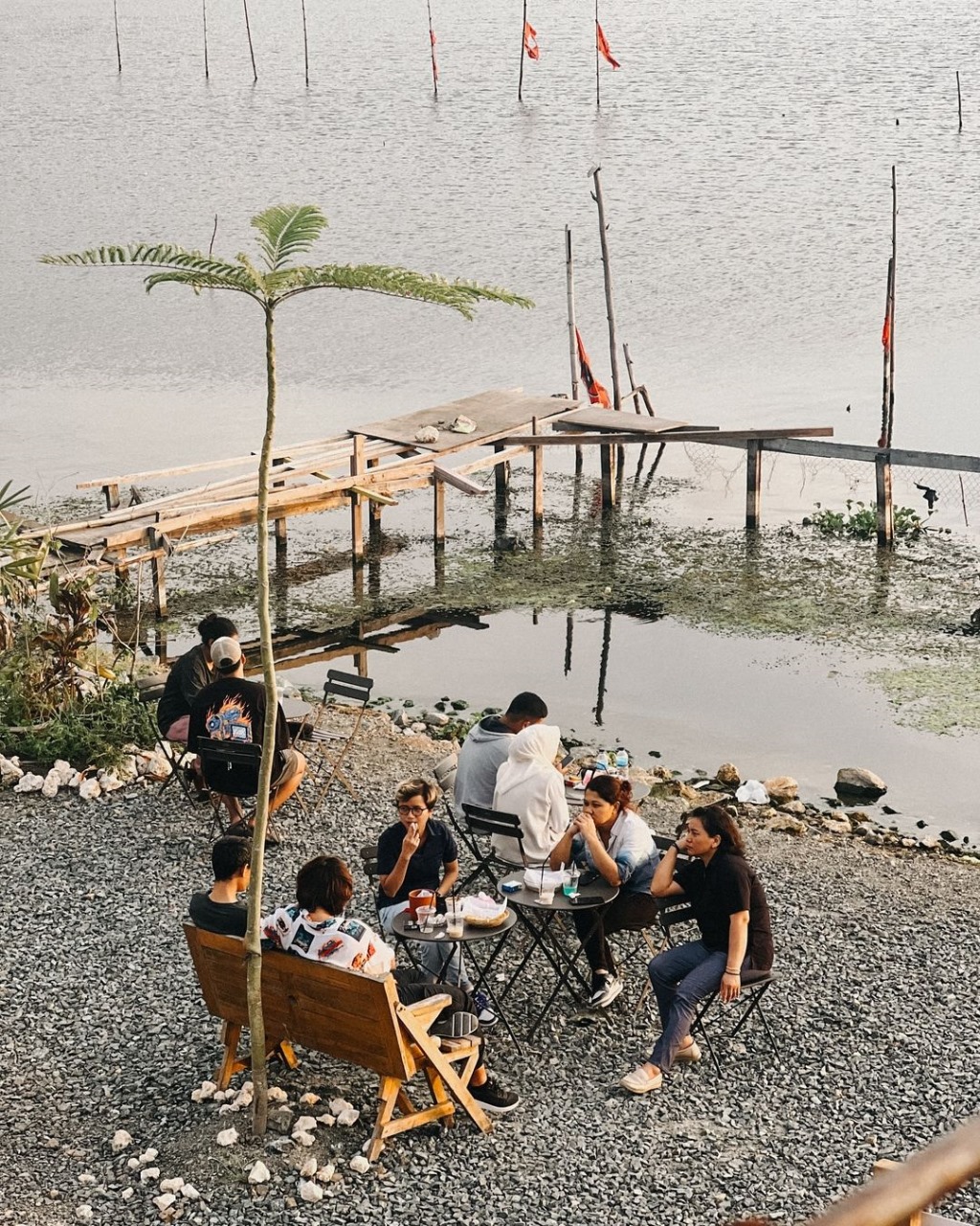 People enjoying coffee by the lake